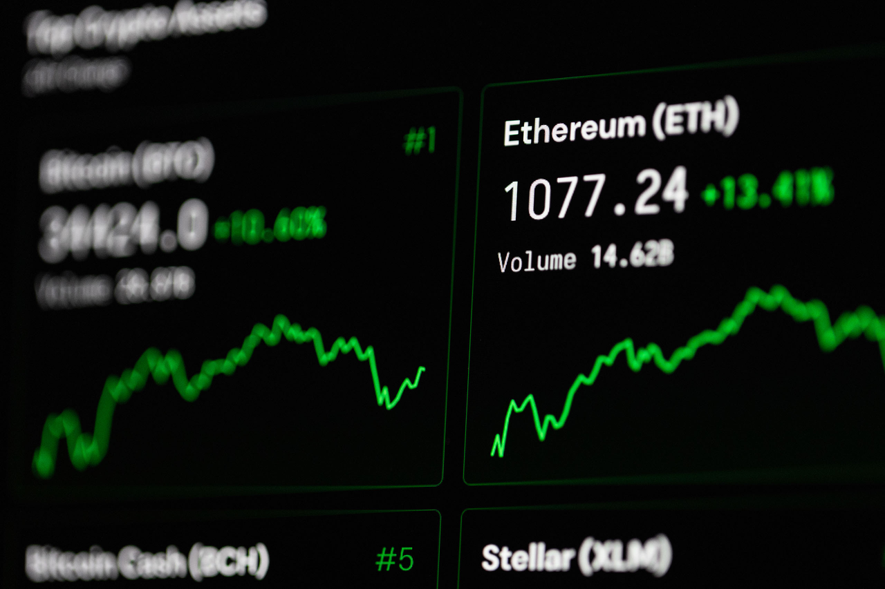 Services Close-up of cryptocurrency market data with Ethereum and Bitcoin prices on screen.